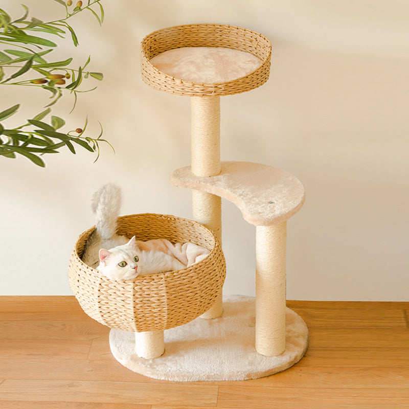 white kitten lying in wicker nest of Sleeping in the Bowl Cat Tree on wooden floor