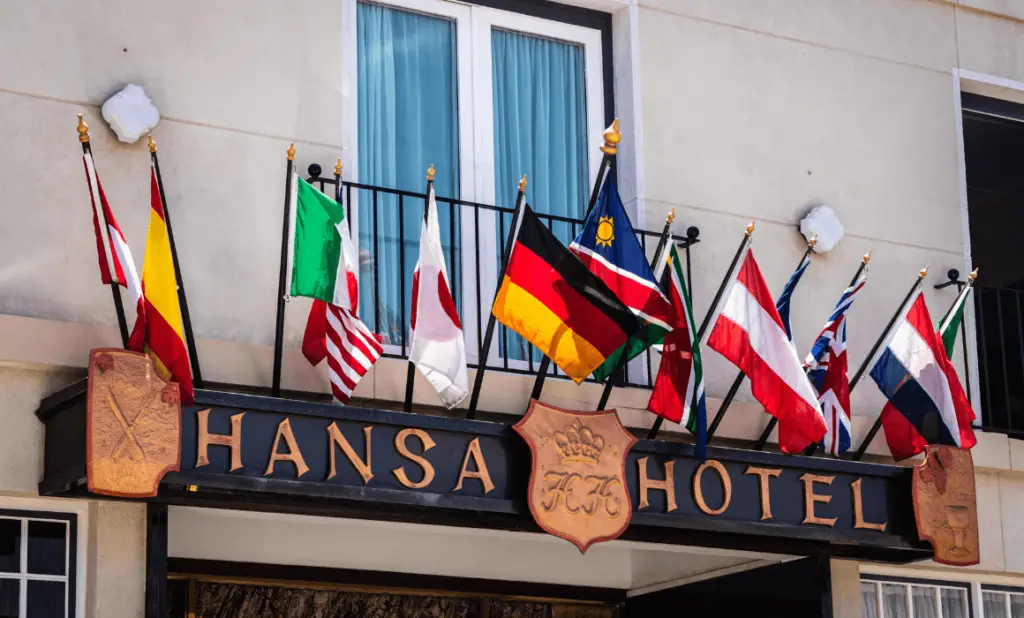 photo of bright flags over a hotel sign. happytogetheranywhere.com