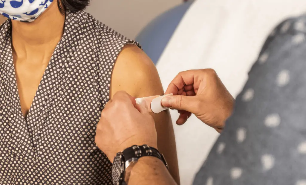 woman getting vaccinated as she prepares for a long trip. happytogetheranywhere.com